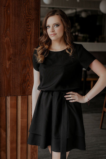 Detail shot of the elegant Tessita dress showing the fine stitching and luxurious blend of polyester and spandex for comfort and style.