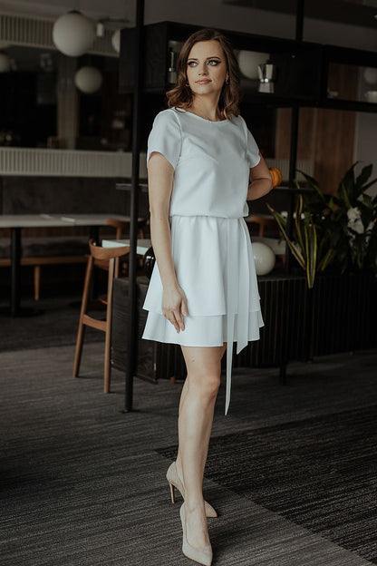 Chic Tessita Daydress showcasing a delicate belt that complements its luxurious design and tailored silhouette.