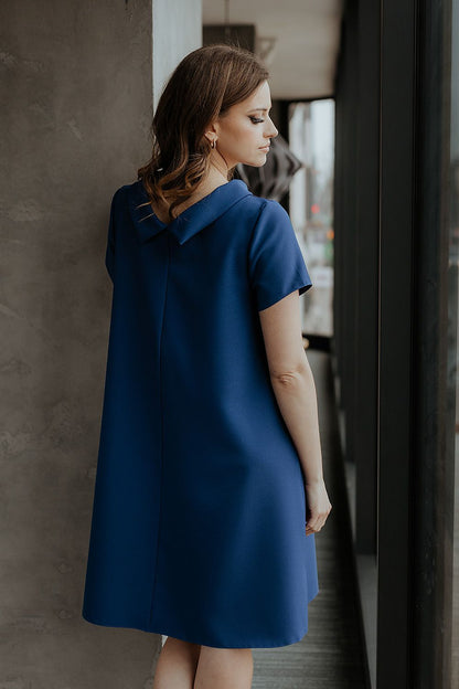Stylish model showcasing Tessita's loose-fitting daydress with Jackie Kennedy collar, embodying timeless elegance and grace.