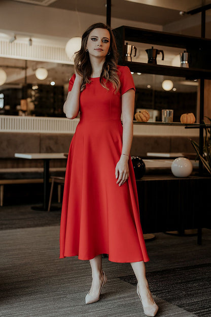 Model wearing a Tessita elegant long dress with short sleeves, beautifully styled for a chic and luxurious look at any event.