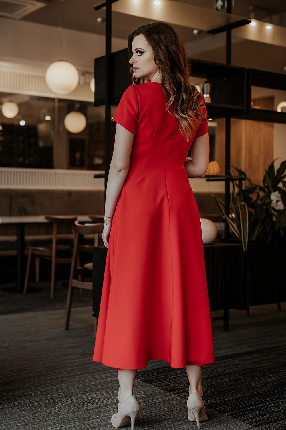 Tessita's elegant long dress captured in a striking pose, highlighting its exquisite craftsmanship and timeless beauty.