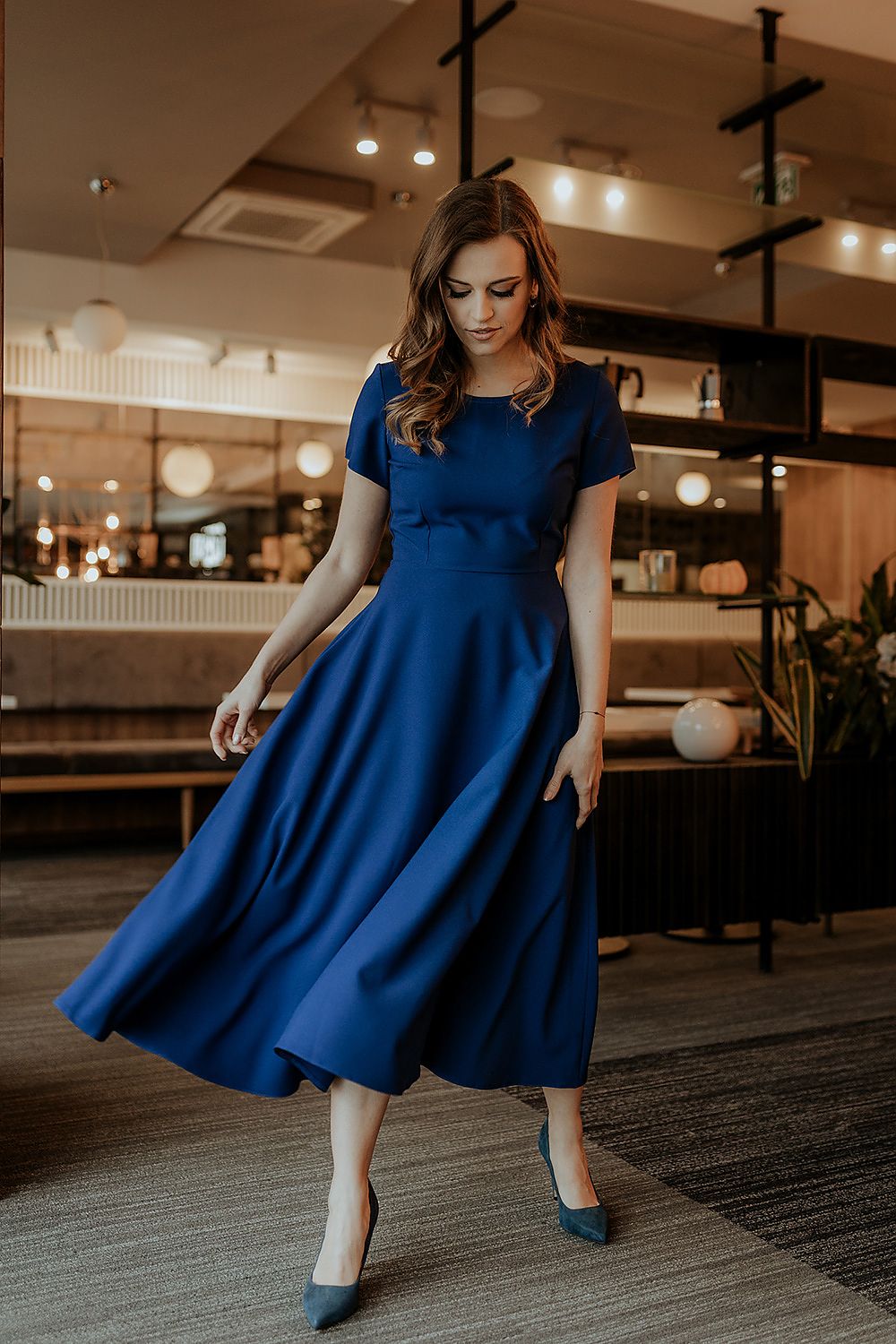 Close-up of Tessita's luxurious fabric for the elegant flared long dress, showcasing the quality and stylish design.