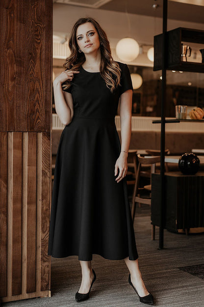 Back view of Tessita's elegant flared long dress highlighting the covered zipper and stylish silhouette.