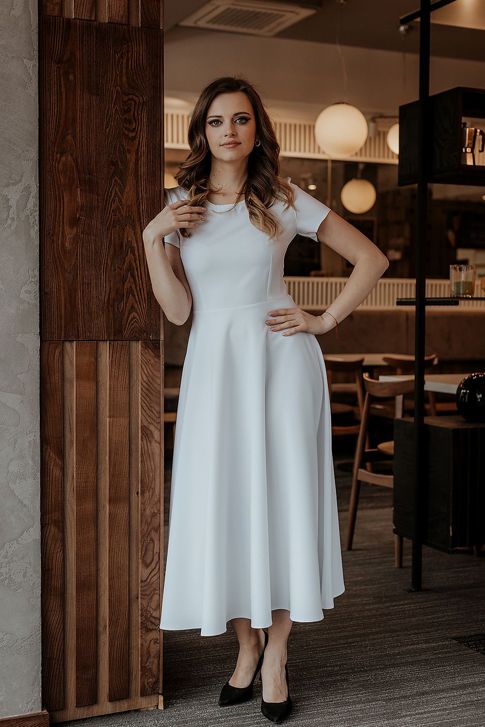 Tessita luxurious long dress showcasing a flared design and short sleeves, perfect for a chic evening event.