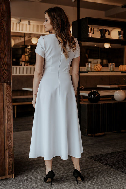 Stylish short-sleeve long dress by Tessita, designed with a flared bottom and covered zipper for a refined look at any event.