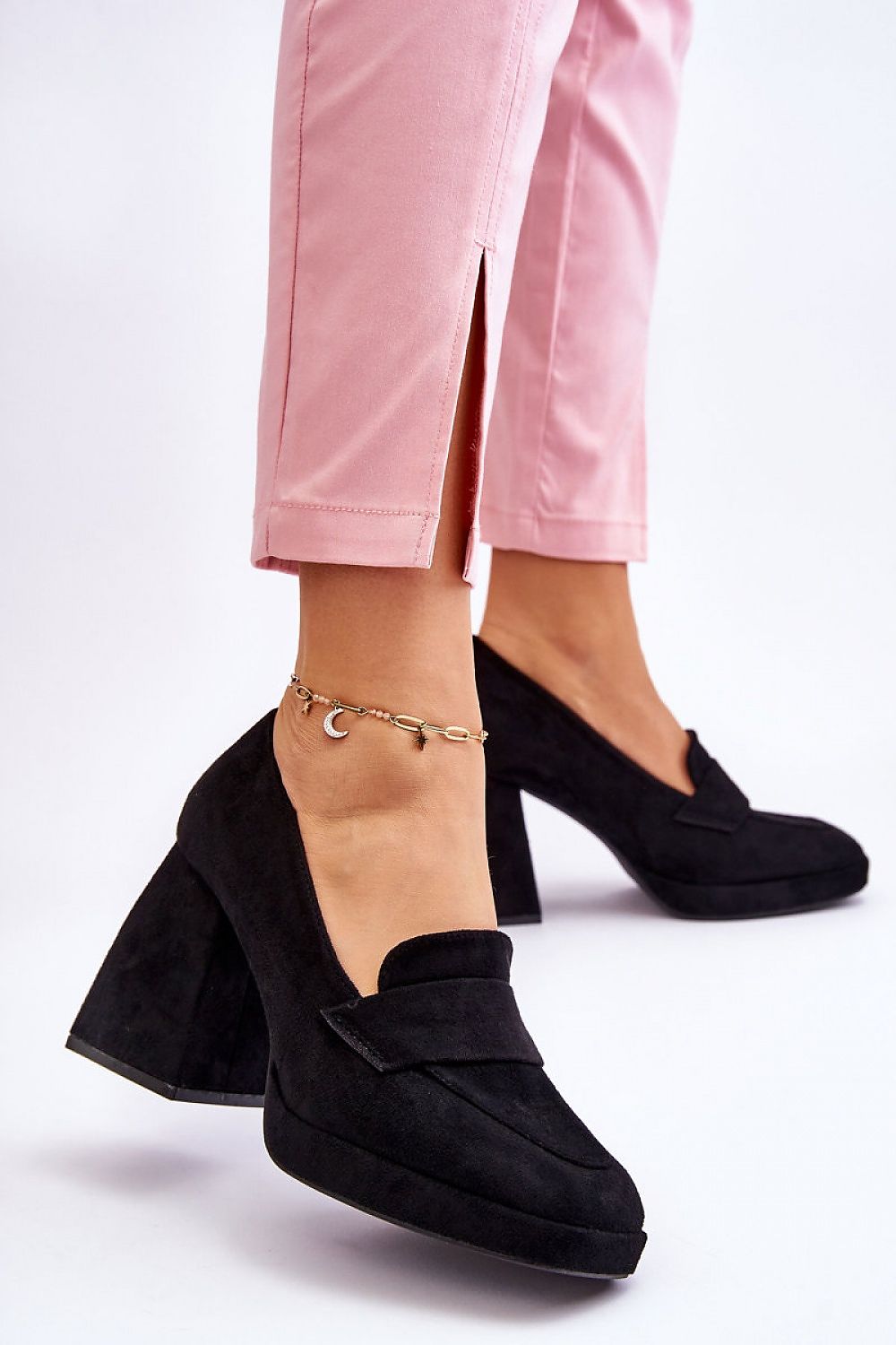 Elegant eco-suede heel pumps by Step in Style, featuring a classic black design and block heel, perfectly styled with pink trousers for a luxurious look.