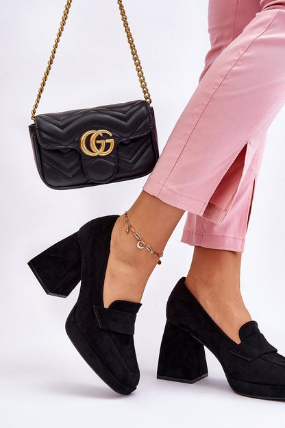 Chic eco-suede heel pumps by Step in Style, showcased with pink trousers and a matching black handbag, ideal for sophisticated fashion statements.