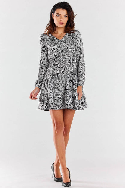 Chic Awama mini dress with long sleeves and V neckline, styled for formal and casual occasions.