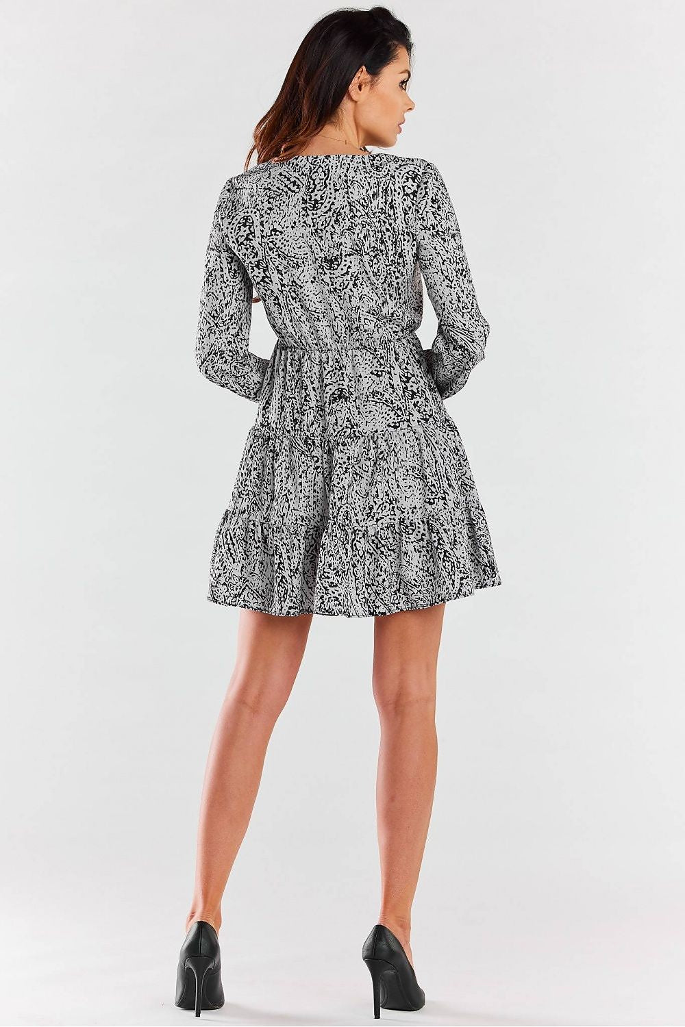 Back view of an elegant Awama mini dress with frills and a sophisticated silhouette.