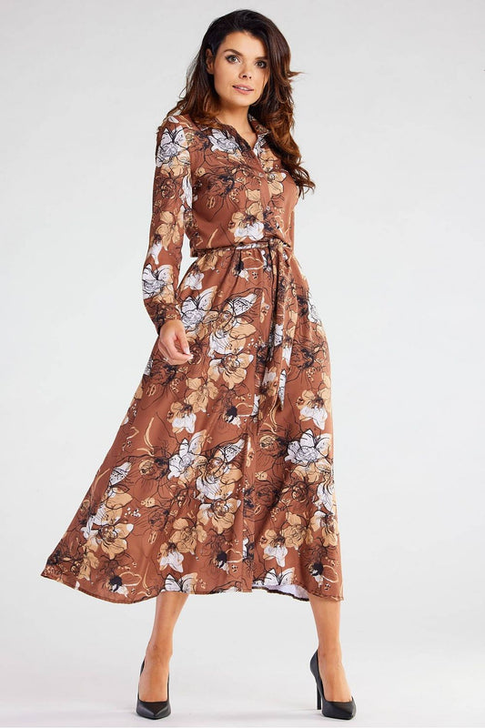 Stunning Awama maxi dress featuring a flared hem and long sleeves, adorned with a floral print in elegant brown hues, ideal for sophisticated occasions.