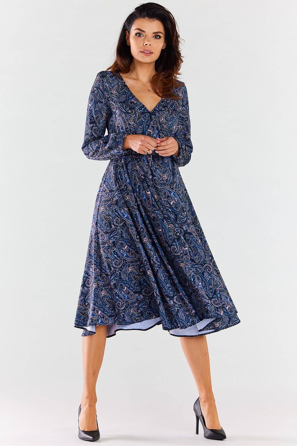 Side view of a luxury midi dress by awama, highlighting the envelope neckline and flared hem, worn by a model accentuating its graceful design.