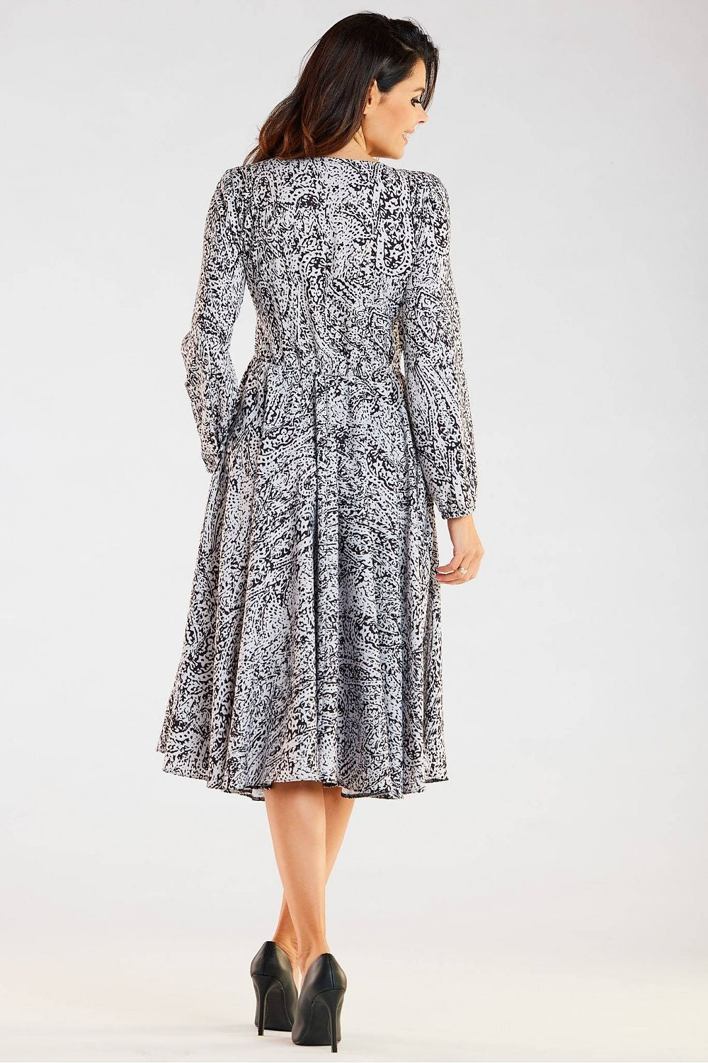 Elegant midi dress by awama featuring a decorative back design, long sleeves, and a flared hem, perfect for sophisticated occasions.