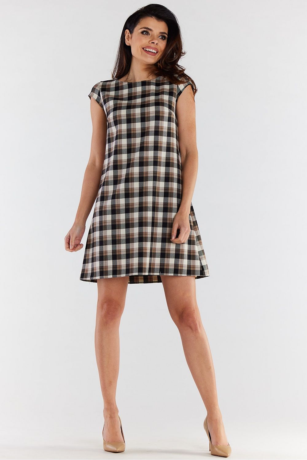 Stylish woman wearing an elegant checkered mini dress with short sleeves by Awama, showcasing a loose trapezoidal cut, perfect for a chic and comfortable look.
