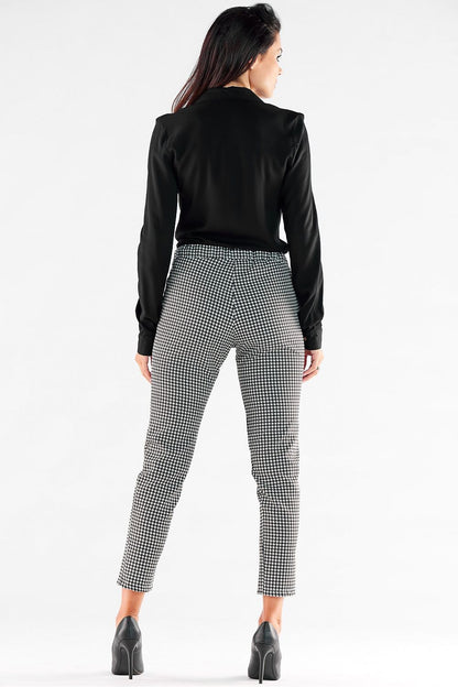 Elegant back view of women's casual trousers with pockets and elastic waist by Awama, styled with a black top, showcasing a sophisticated check pattern.