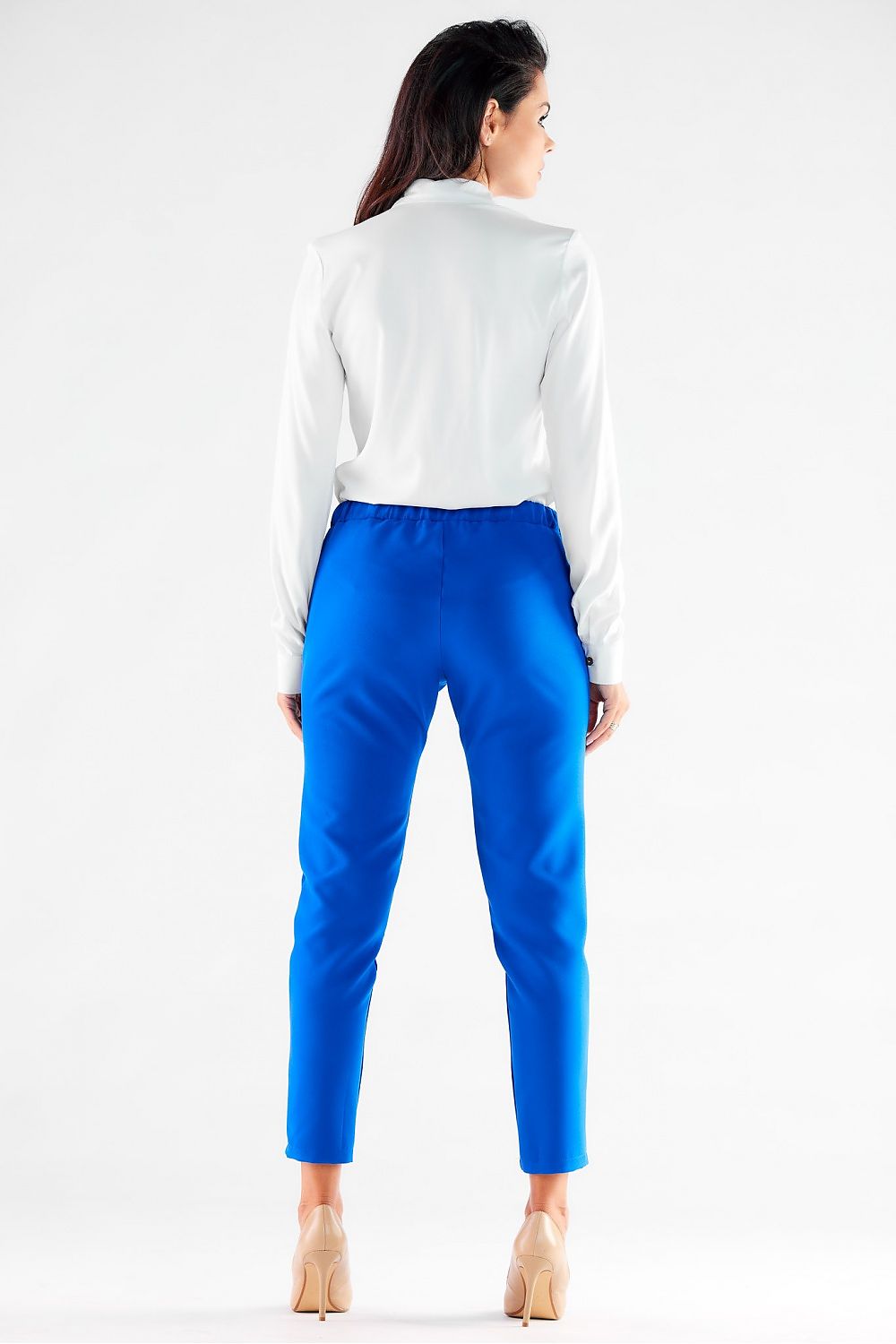 Smart back view of a model wearing luxurious blue trousers by Awama, elegantly matched with a white shirt, capturing a contemporary yet timeless style.