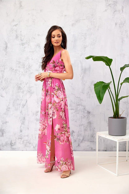 Stylish pink floral chiffon maxi dress by Roco Fashion, showcasing a flattering leg slit and sophisticated envelope neckline, ideal for upscale events.