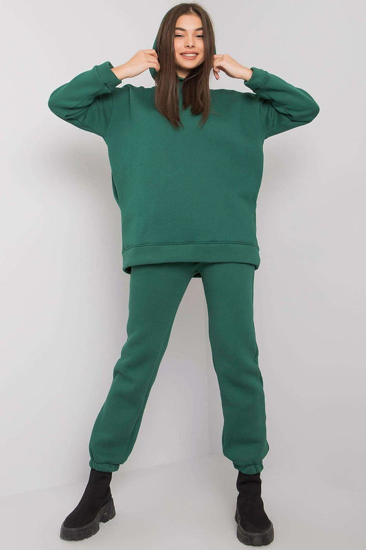 Elegantly styled woman showcasing a luxurious BFG cotton-blend sweatshirt set in rich green, featuring a hood and matching elastic waist pants.
