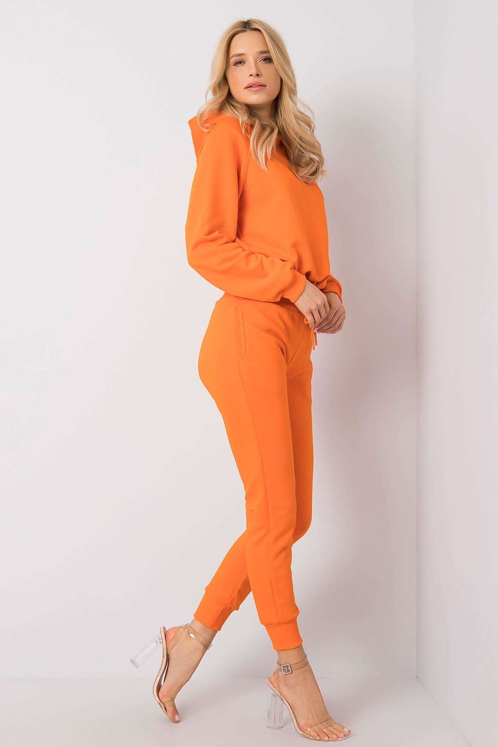 Side view of the Luxury BFG Cotton Spandex Hoodie Sweater and Fitted Pants Set in bright orange, showcasing the elegant silhouette and stylish cuts perfect for contemporary fashion.