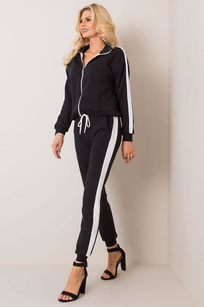 BFG Women's Luxury Zip-Up Sweatshirt Set in black, featuring contrasting white piping, modeled by a stylish woman walking confidently in high heels, showcasing both elegance and comfort.
