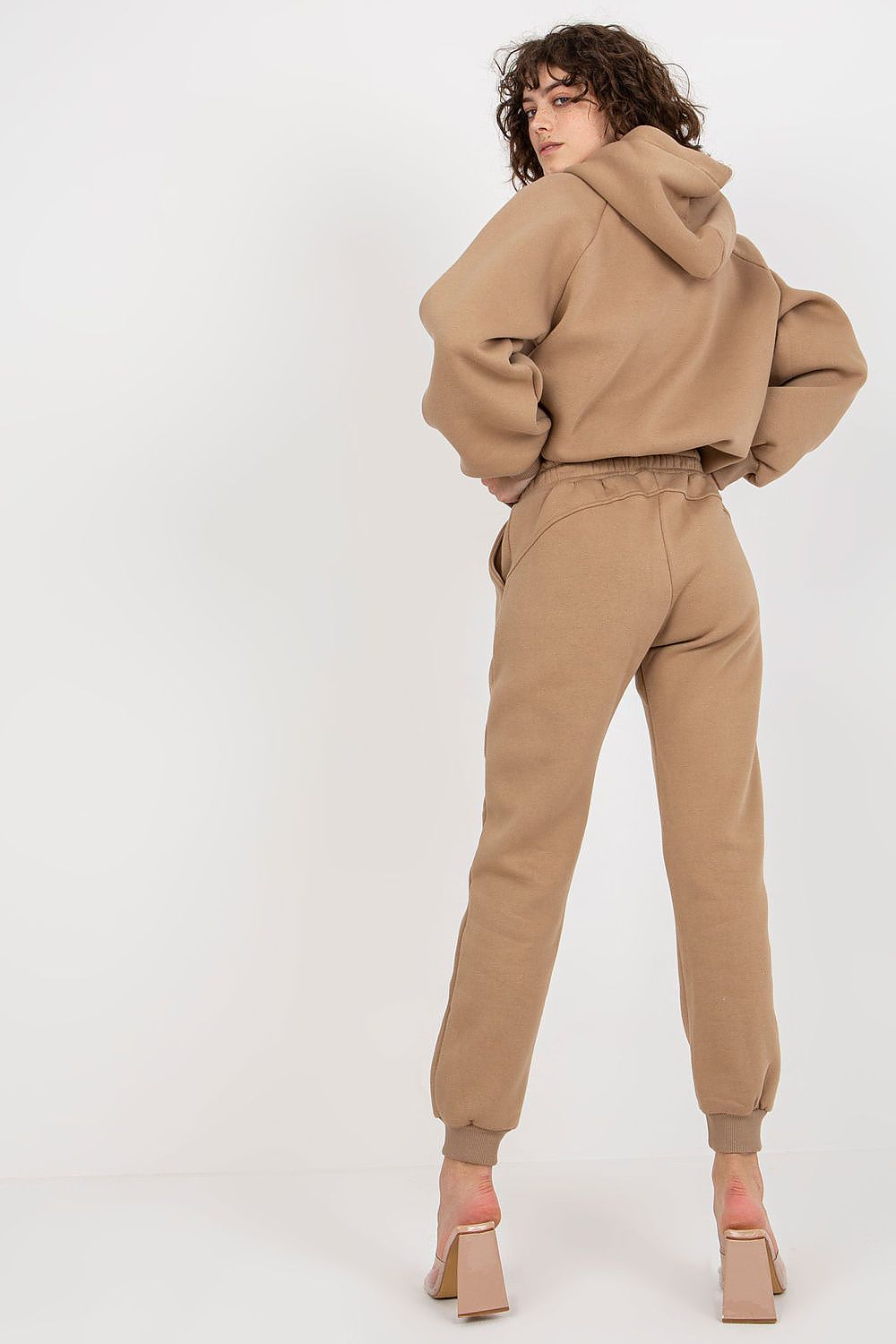 Stylish Ex Moda Premium Cotton-Blend Sweatshirt Set featuring a model with her back turned, highlighting the hooded sweatshirt and tailored fit of the pants in a sophisticated beige colour.
