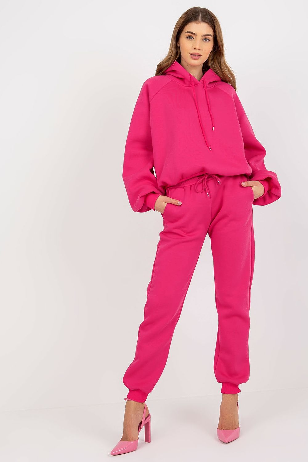 Ex Moda bold pink cotton-blend sweatshirt and pants ensemble, model posing confidently, epitomising luxury casual wear.