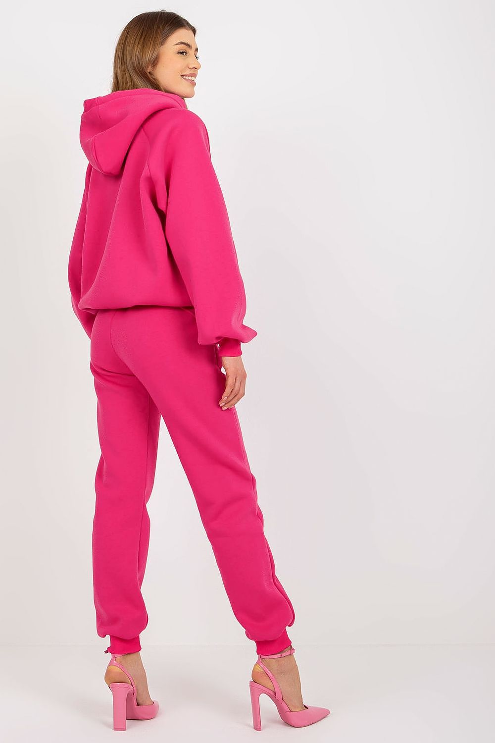 Elegant model showcasing the Ex Moda Premium Cotton-Blend Sweatshirt Set in vibrant pink, featuring a hood and stylish long pants, exuding luxury and comfort.