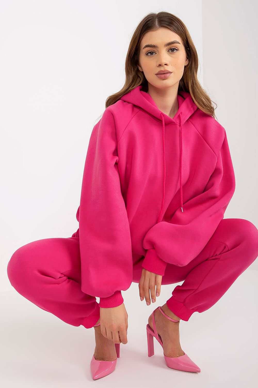 Chic model leisurely posed in pink Ex Moda Premium Cotton-Blend Sweatshirt Set, highlighting the hoodie and tailored long pants for an upscale athleisure look.