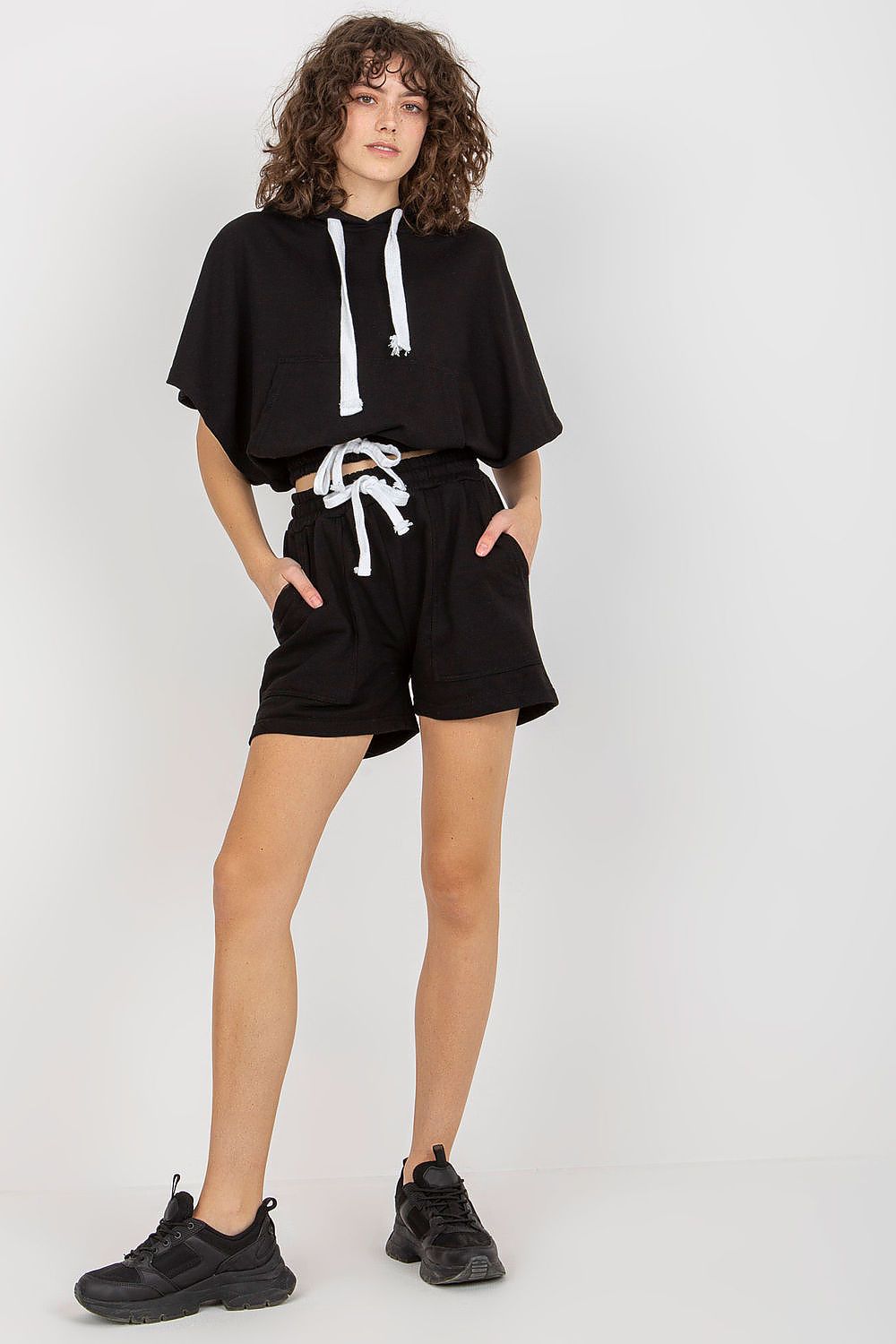 Fashionable black tracksuit set from Ex Moda, showcasing a stylish oversized hoodie and tailored shorts, combining comfort with luxury.
