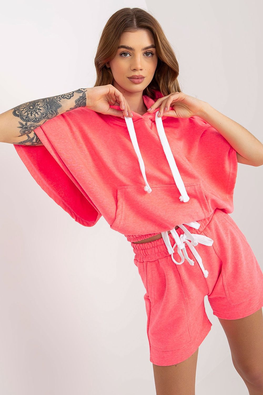 Vibrant pink Luxury Ex Moda Tracksuit Set highlighted by a trendy hoodie with short sleeves and stylish shorts with pockets, ideal for a fashionable casual look.