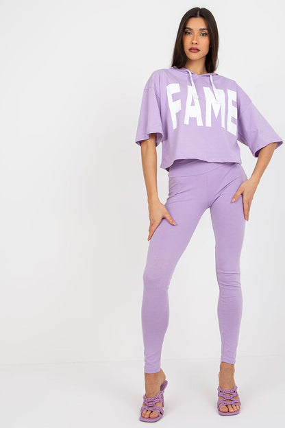 Luxury Ex Moda women's cotton sweatshirt and leggings set in lavender, featuring bold 'FAME' inscription, styled with matching heels.