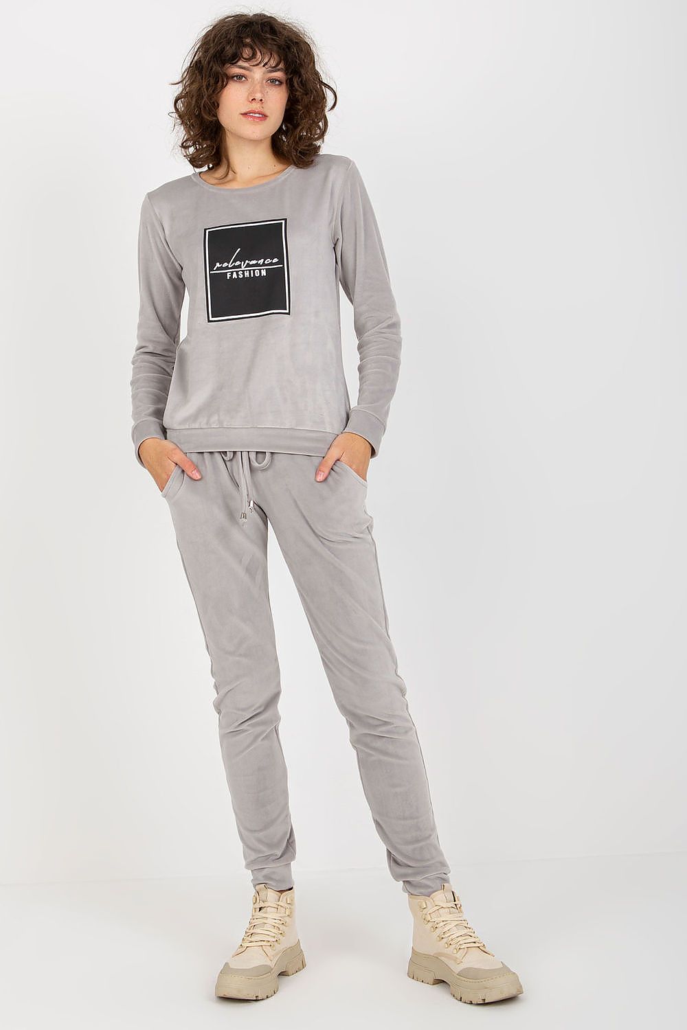 Stylish luxurious velour tracksuit set by Relevance featuring a grey sweatshirt with a decorative black graphic and long pants with pockets, perfect for comfortable wear.