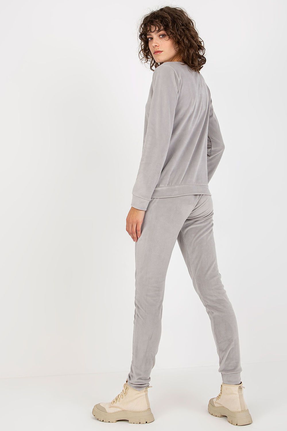 Sophisticated velour tracksuit set by Relevance, featuring a stylish sweatshirt and long pants, showcased in a soft grey colour with a modern silhouette.