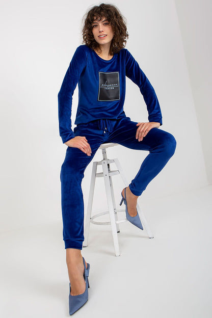 Elegant velour tracksuit set by Relevance, displayed in a rich blue hue. The outfit features a chic sweatshirt with a decorative print and matching drawstring pants.