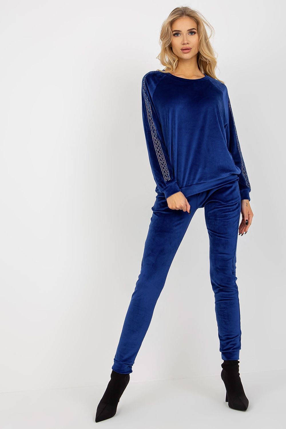 Sophisticated blue velour lounge set featuring a long-sleeve blouse with rhinestone details and matching long pants, designed by Relevance for an elegant style.