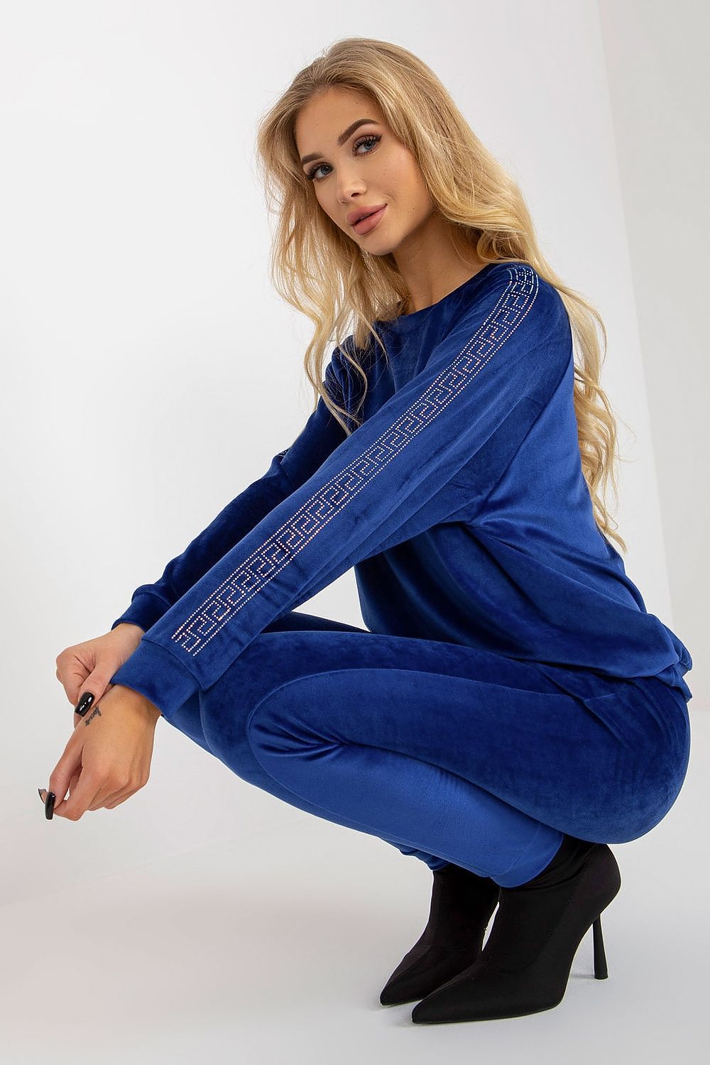 Chic blue velour outfit showcasing a stylish long-sleeve blouse with rhinestone embellishments and coordinated trousers, created by Relevance for a luxurious look.