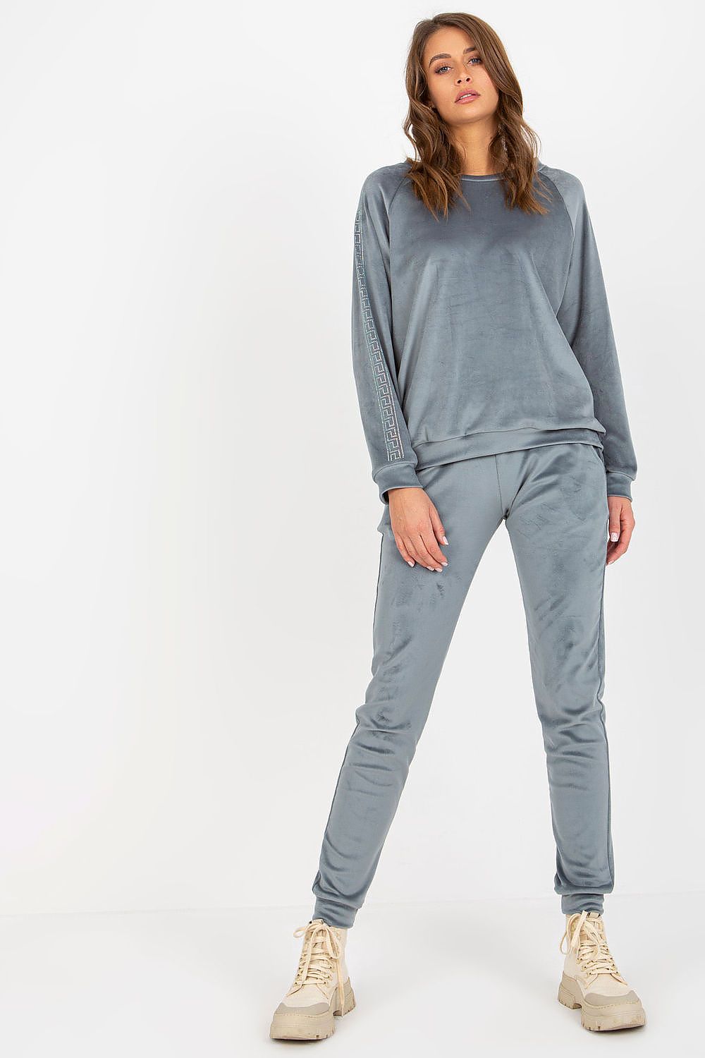Relevance sophisticated velour set in grey, highlighting a comfortable and stylish blouse with decorative rhinestones and fitted long pants.