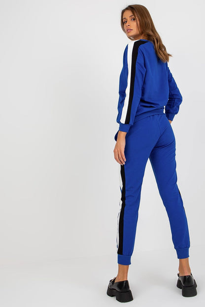 Elegant woman showcasing a luxury cotton and spandex sweatshirt set in blue with two-tone stripes, featuring a relaxed fit and stylish tie-waist pants, designed by Relevance.