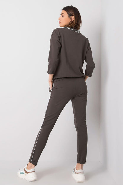 Back view of a woman adorned in the Elegant Women's 2-Piece Tracksuit Set by Relevance, highlighting the elegant sporty style with a stylish collar and comfortable fit.