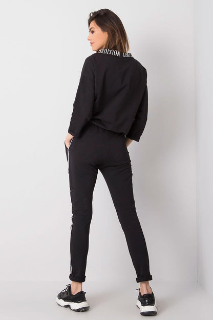 Sophisticated back view of a ladies' black tracksuit set, highlighting the trendy design and attention to detail, crafted by Relevance.