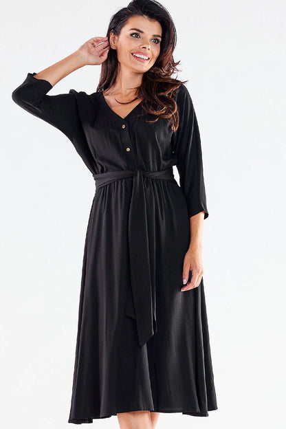 Chic black midi dress by awama with a trapezoidal hem and belt, embodying sophistication for any event.