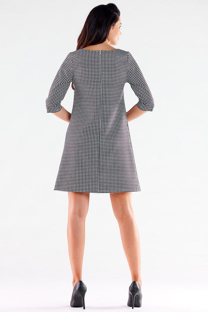 Stylish back view of a houndstooth mini daydress with 3/4 sleeves by awama, featuring a flattering trapezoidal cut and elegant design.