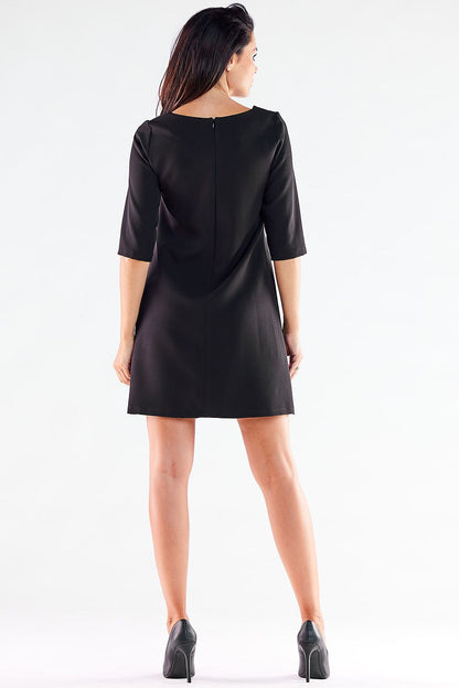 Rear view of an elegant mini daydress by awama, highlighting the covered zipper closure and refined trapezoidal design.