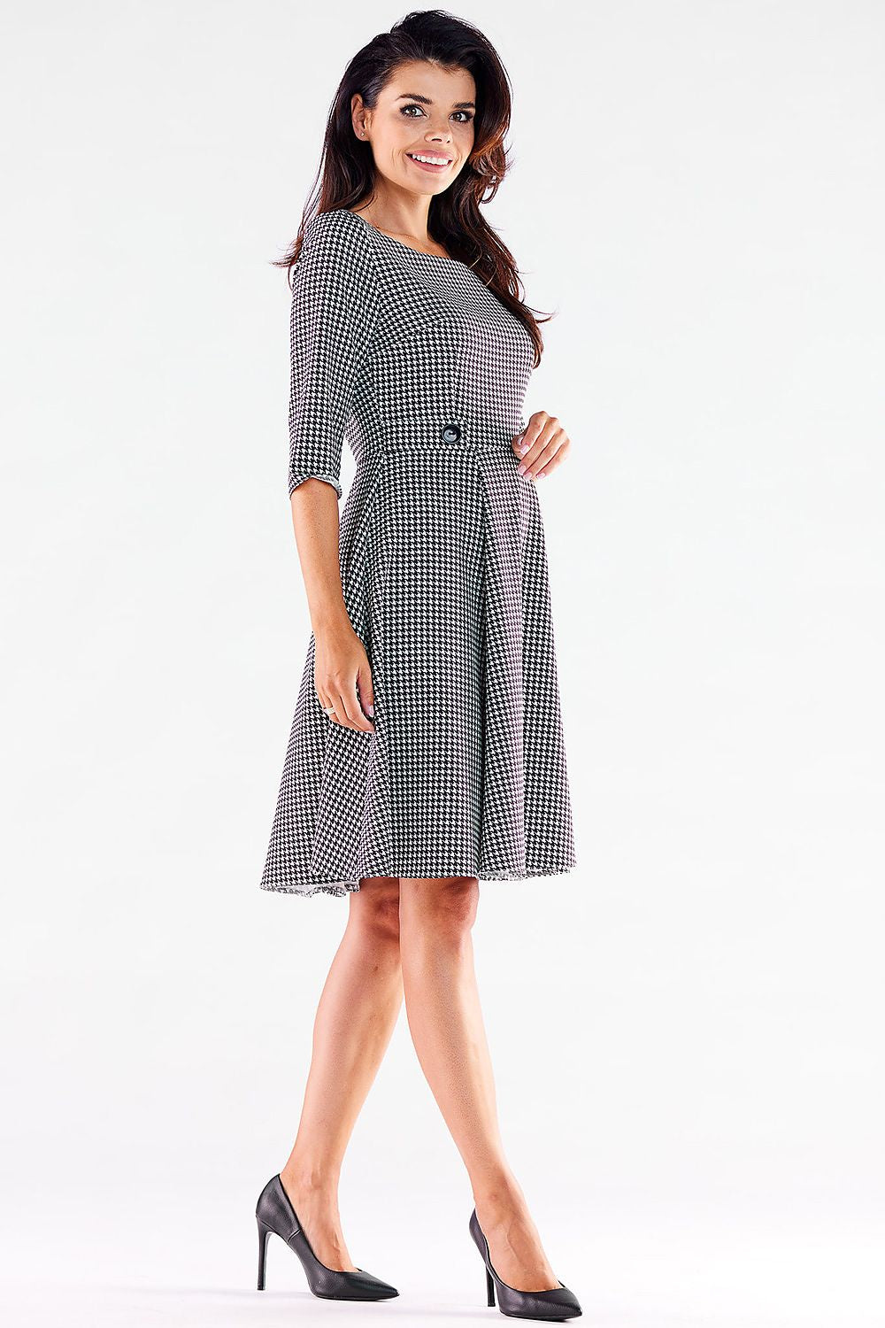 Stylish Awama daydress in houndstooth, boasting a sophisticated fit and decorative buttons for added charm.