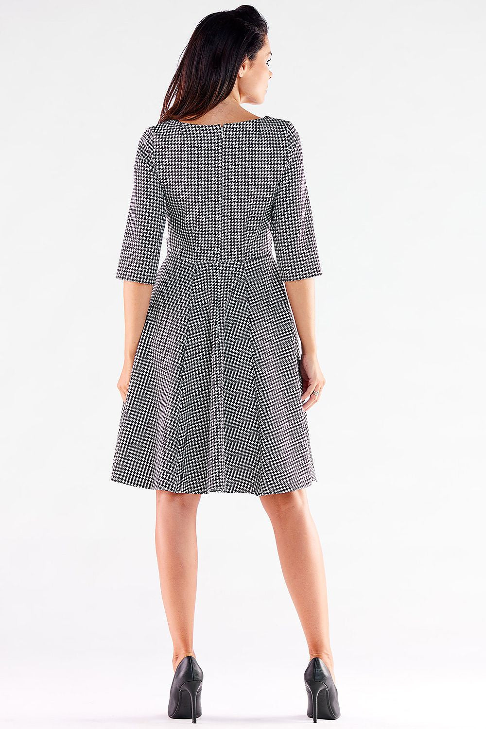 Sleek black and white houndstooth Awama daydress, designed to enhance the figure with a flattering silhouette and elegant buttons.