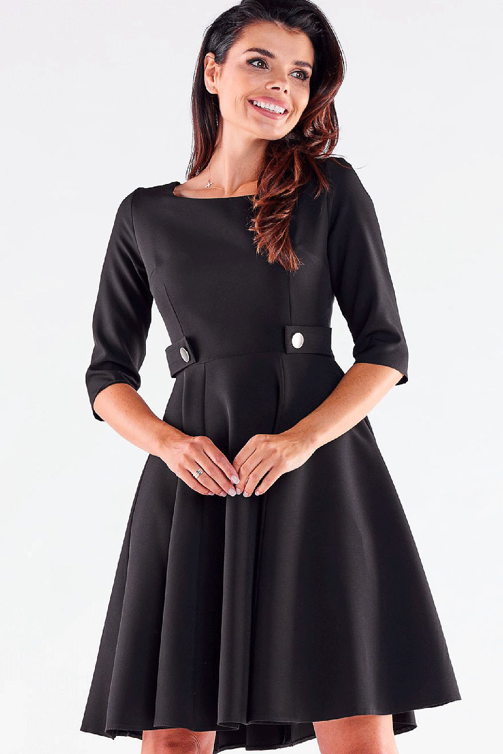 Chic woman smiling in a sophisticated black Blushed Awama daydress, designed with decorative buttons and a flattering fit and flare silhouette.