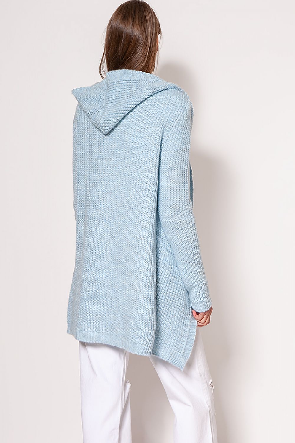 Back view of MKM luxurious soft cardigan coat in light blue, highlighting the minimalist design and cozy hood, paired with stylish white trousers.