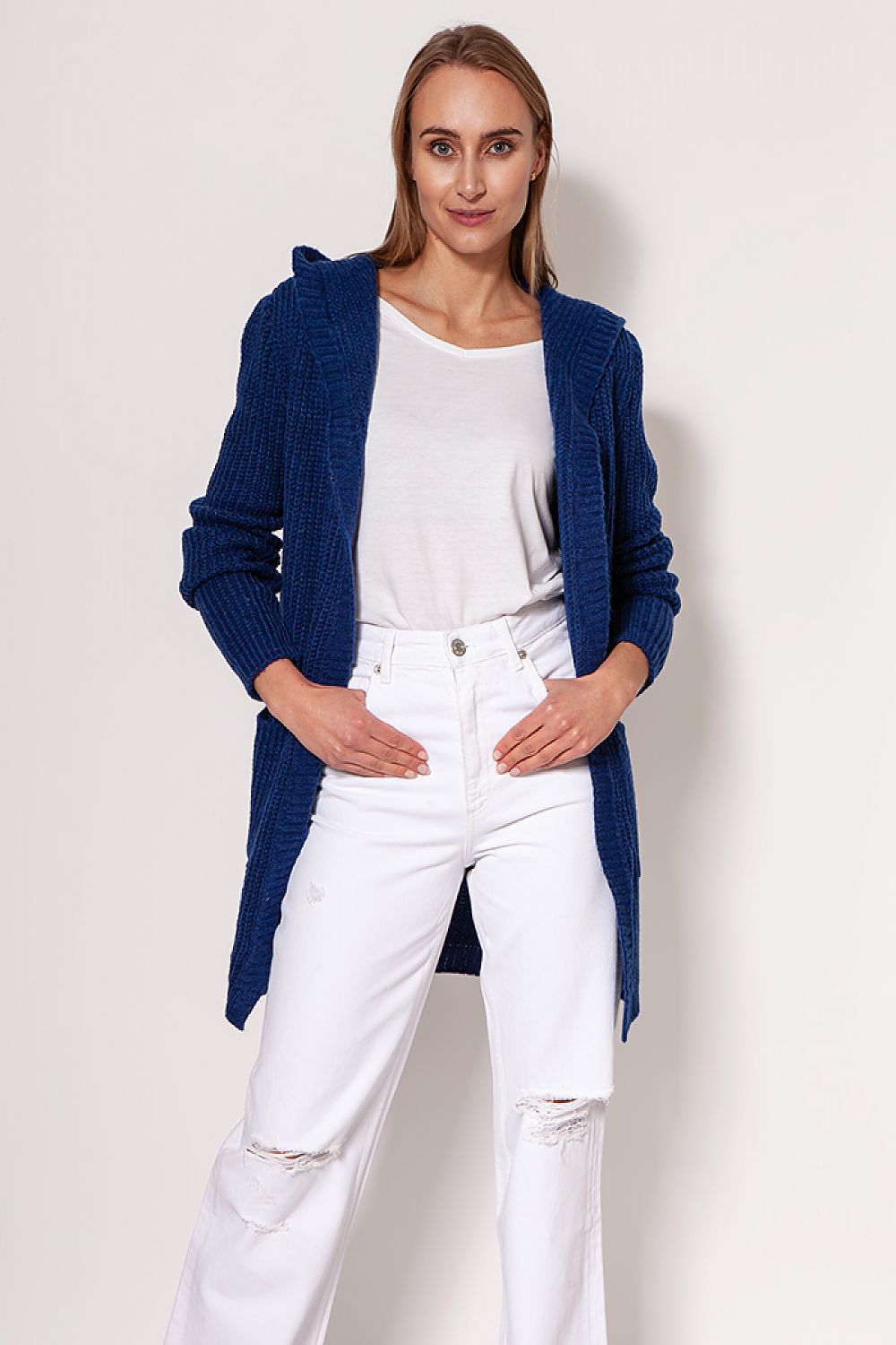 MKM luxurious soft cardigan coat in deep blue, showcasing a chic minimalist style with a hood, elegantly worn over a white top and distressed jeans.
