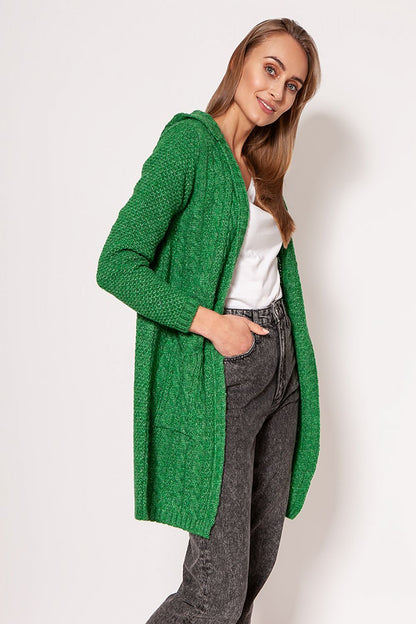 MKM Soft Cardigan Coat in vibrant green, featuring a minimalist design, dropped shoulders, and hip pockets. Model elegantly styled with jeans, showcasing versatility and luxury.