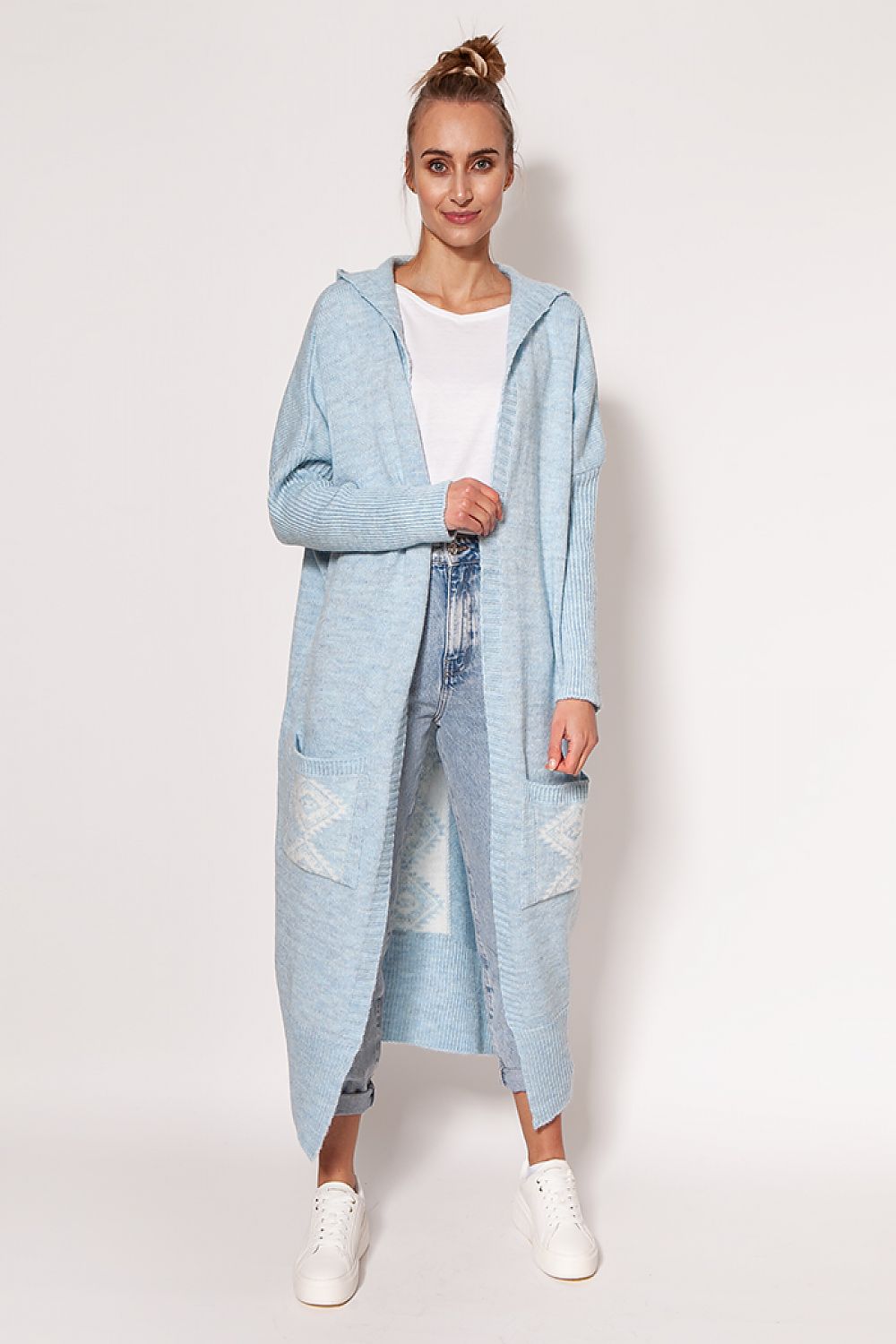 Stunning MKM extended cut cardigan in light blue, elegantly worn by a model, featuring a cozy hood and generous pockets for a luxurious style.