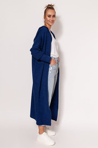 Stylish woman in a navy MKM extended cut cardigan with hood, paired with relaxed fit jeans and white footwear, exuding casual luxury.